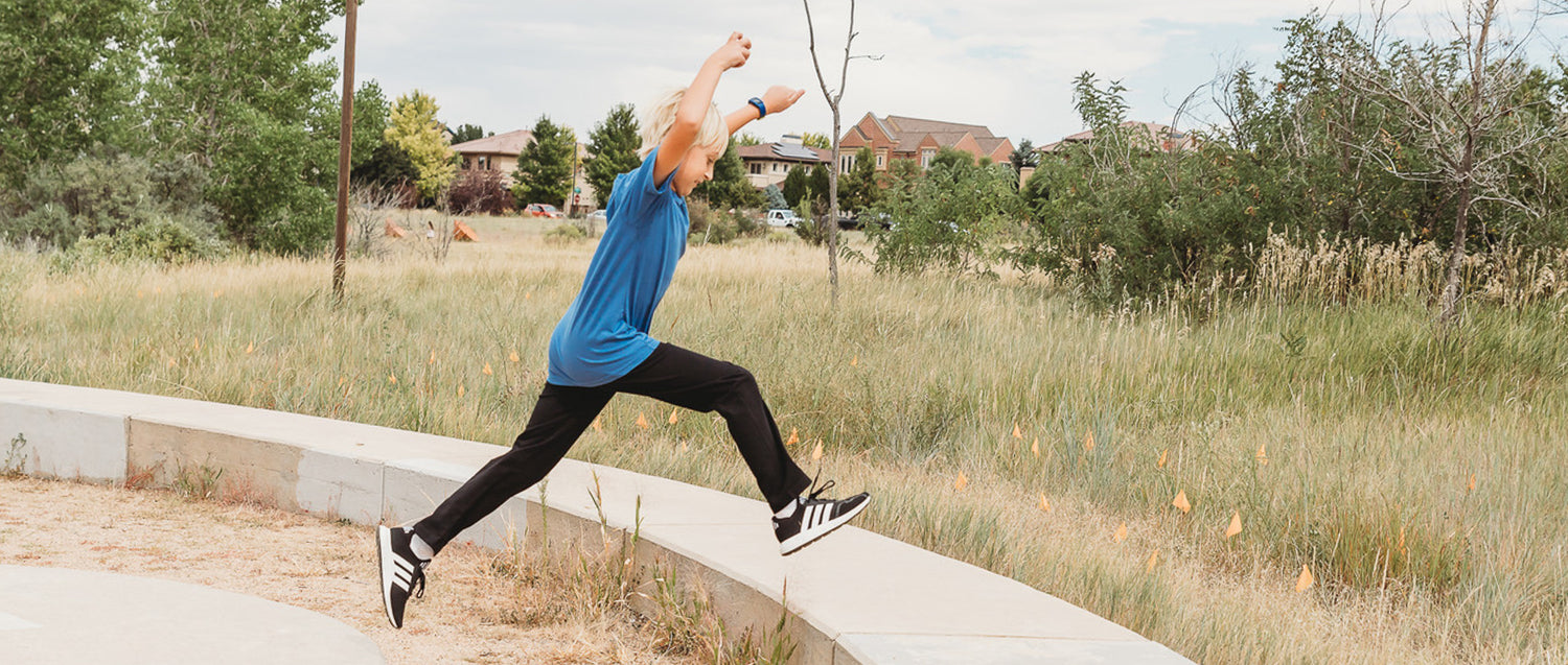 Boy having fun outdoors in comfortable 100% cotton athletic pants and tee shirt from City Threads