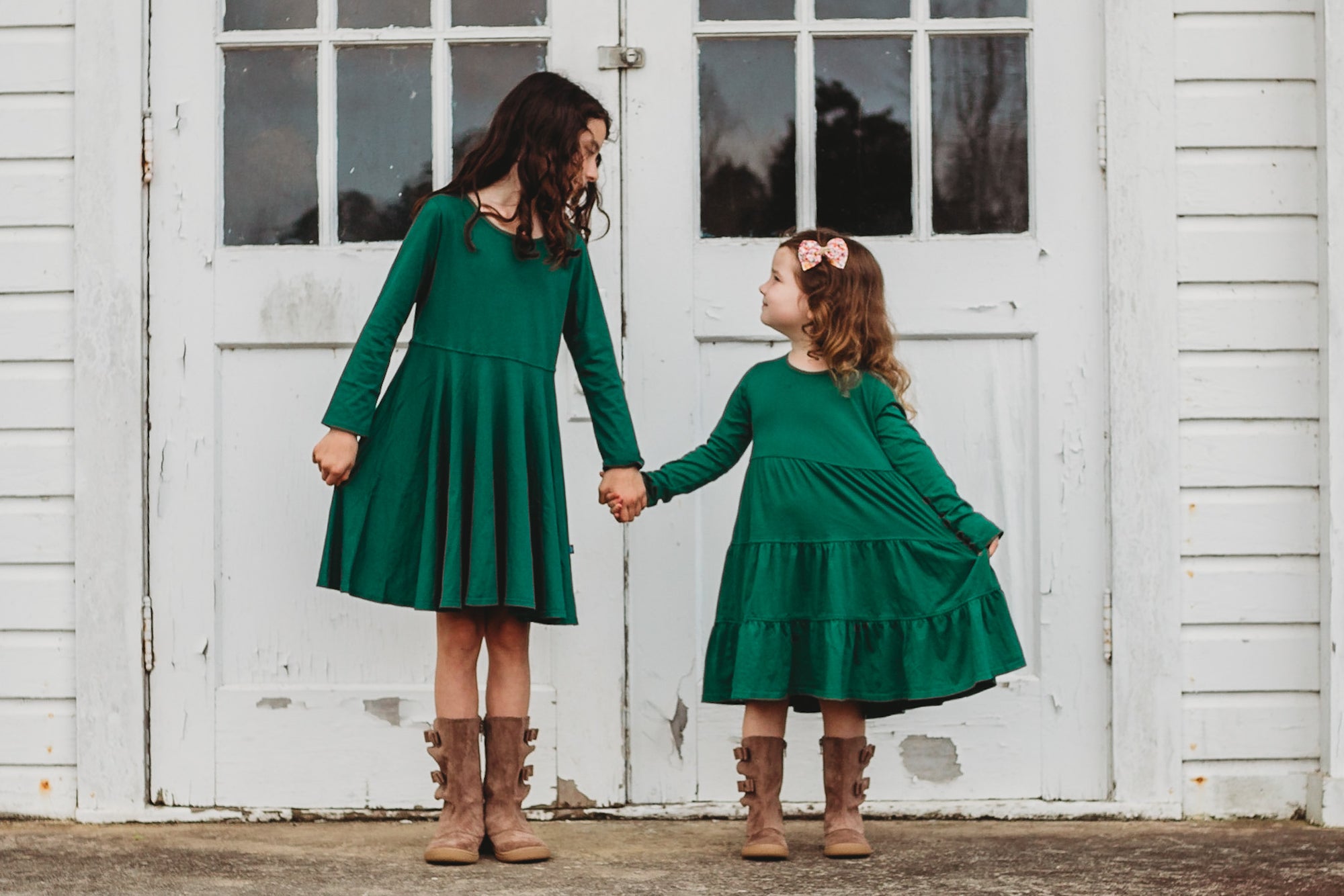 Two girls in cute 100% organic cotton dresses ready for St. Patricks Day.