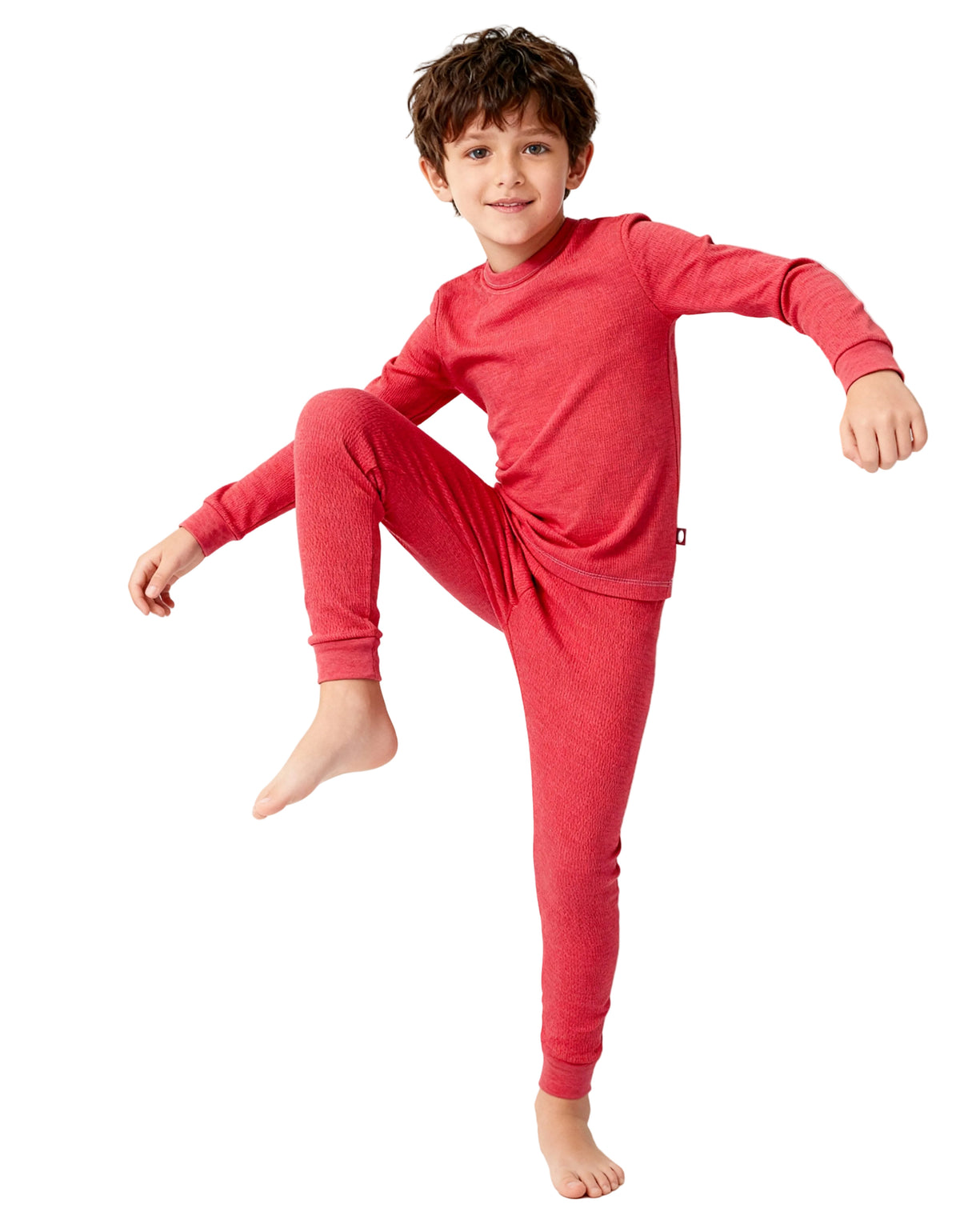 Child wearing a red pajama set on a light gray background