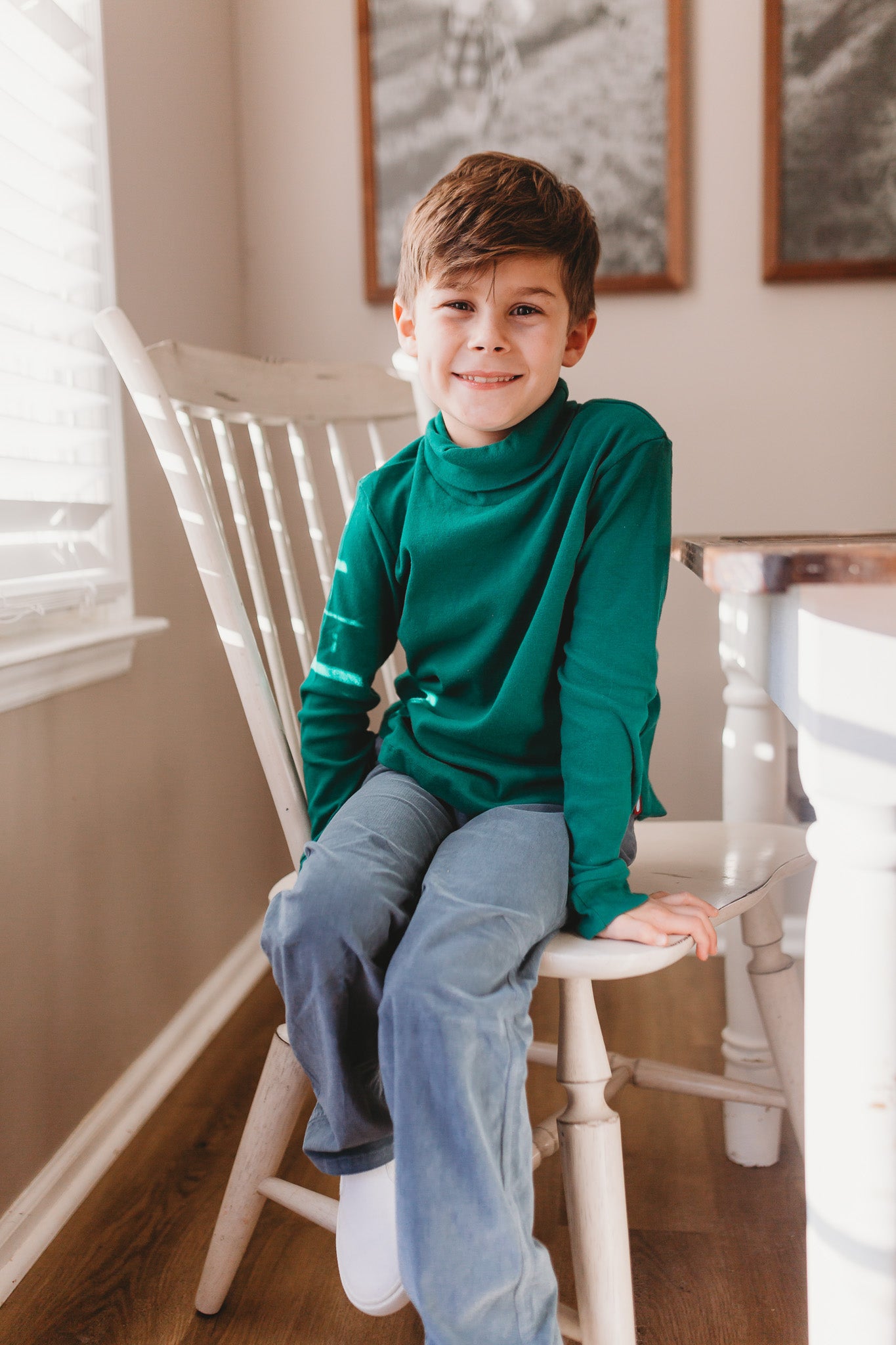 Boy sitting on chair ready for Thanksgiving dinner in his City Threads clothing.