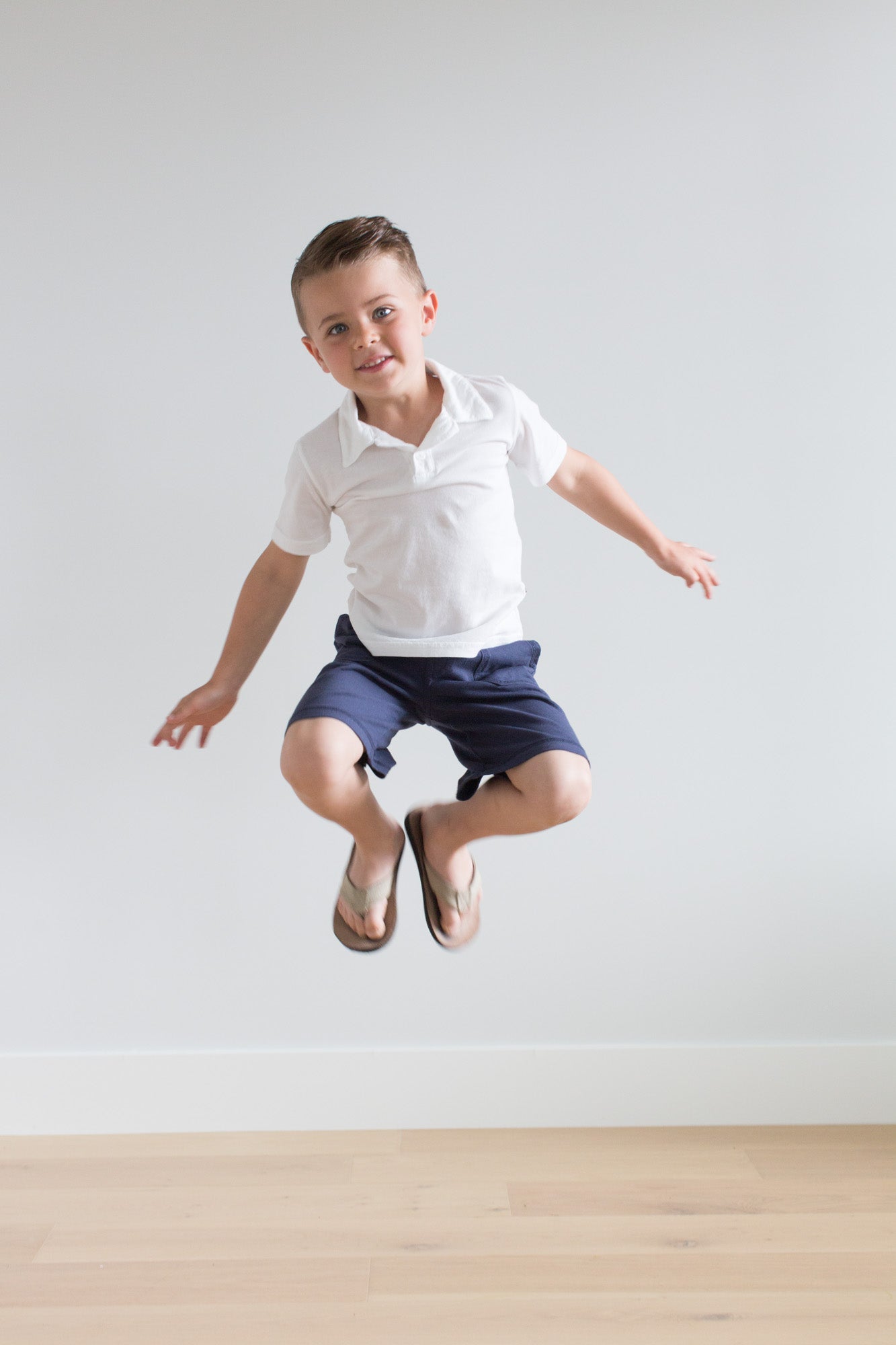 Boy jumping for joy in his comfortable school clothing.