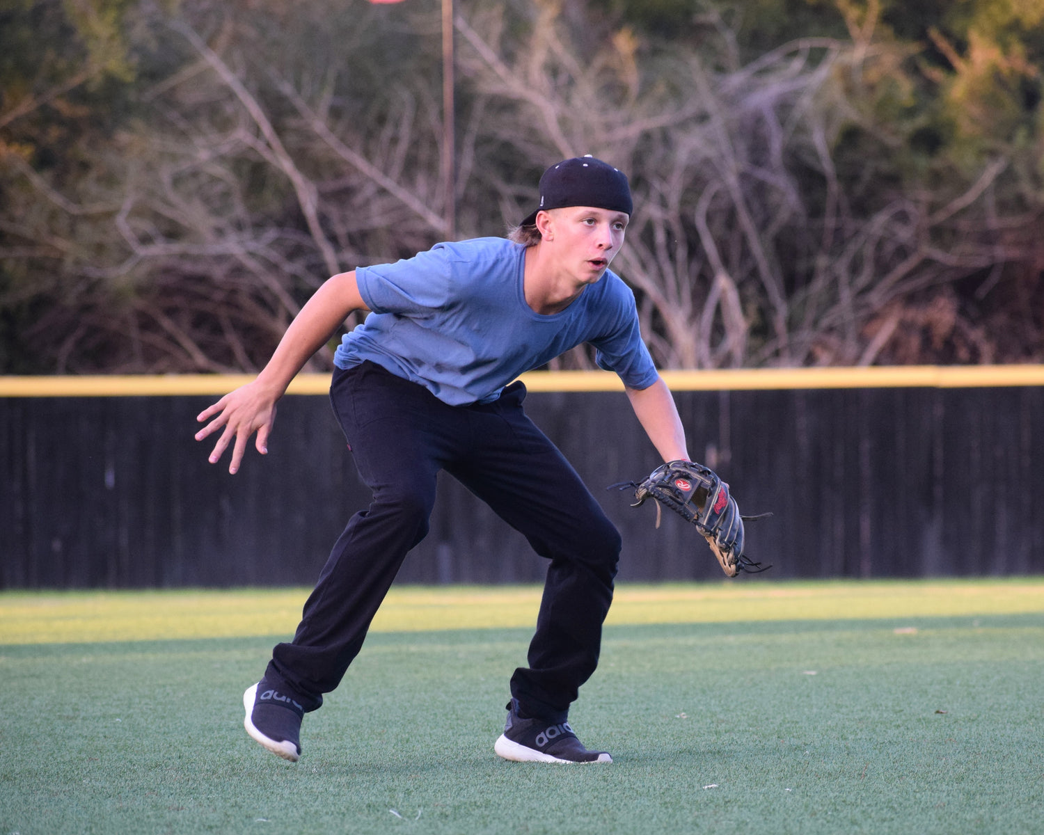 Boy playing baseball in jersey knit pants.