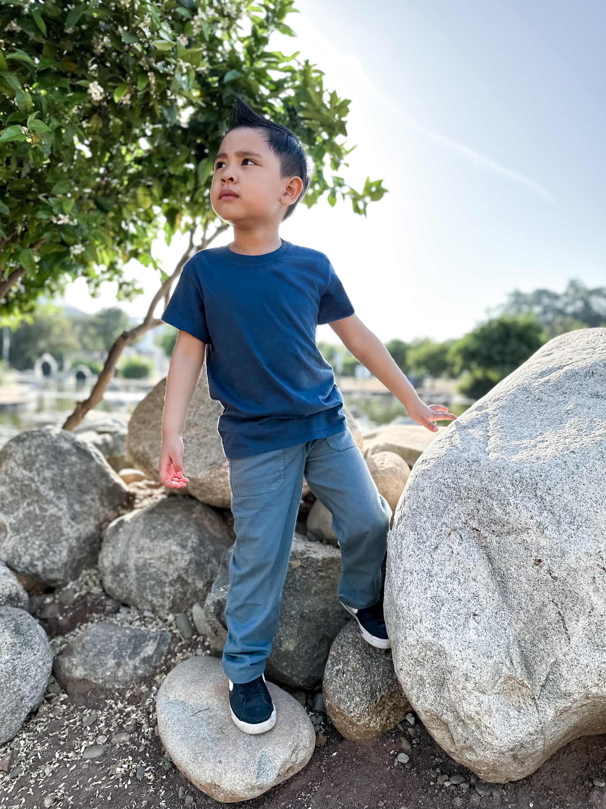 Boy playing outside in his 3 pocket jersey pant having fun