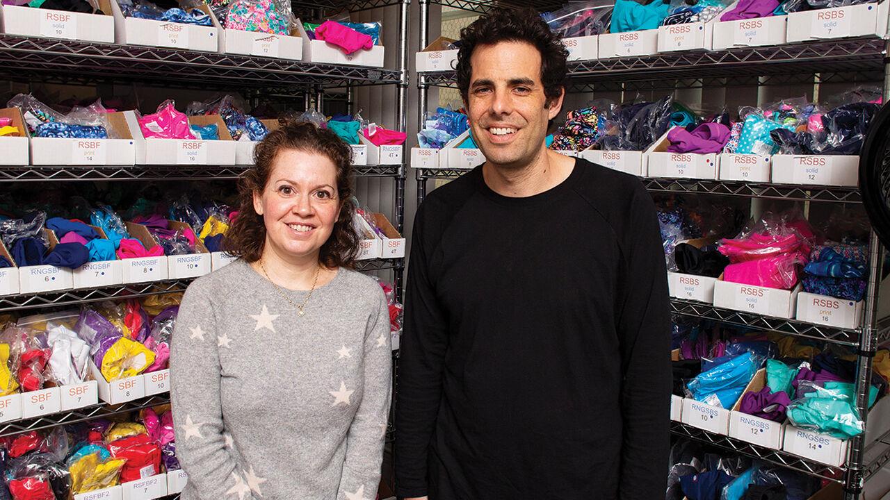 City Threads owners Joe and Shayna pictured in their local warehouse of clothing that is made in the USA photo