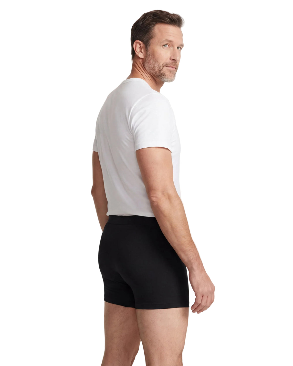 Man wearing a white t-shirt and black underwear on a white background
