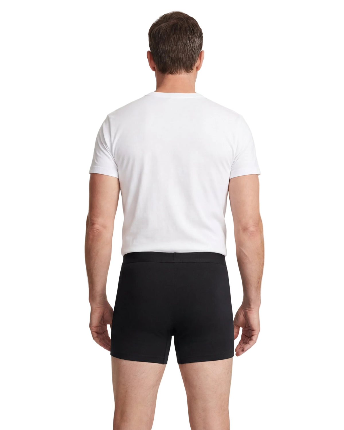 Man wearing a white t-shirt and black boxer briefs on a white background