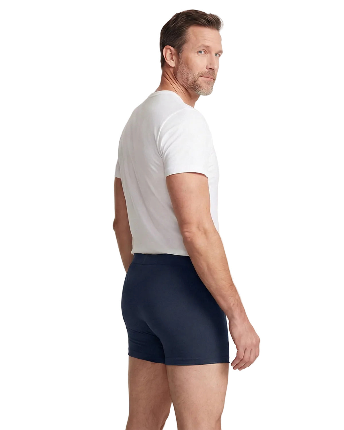 Man wearing navy boxer briefs and a white t-shirt on a light gray background