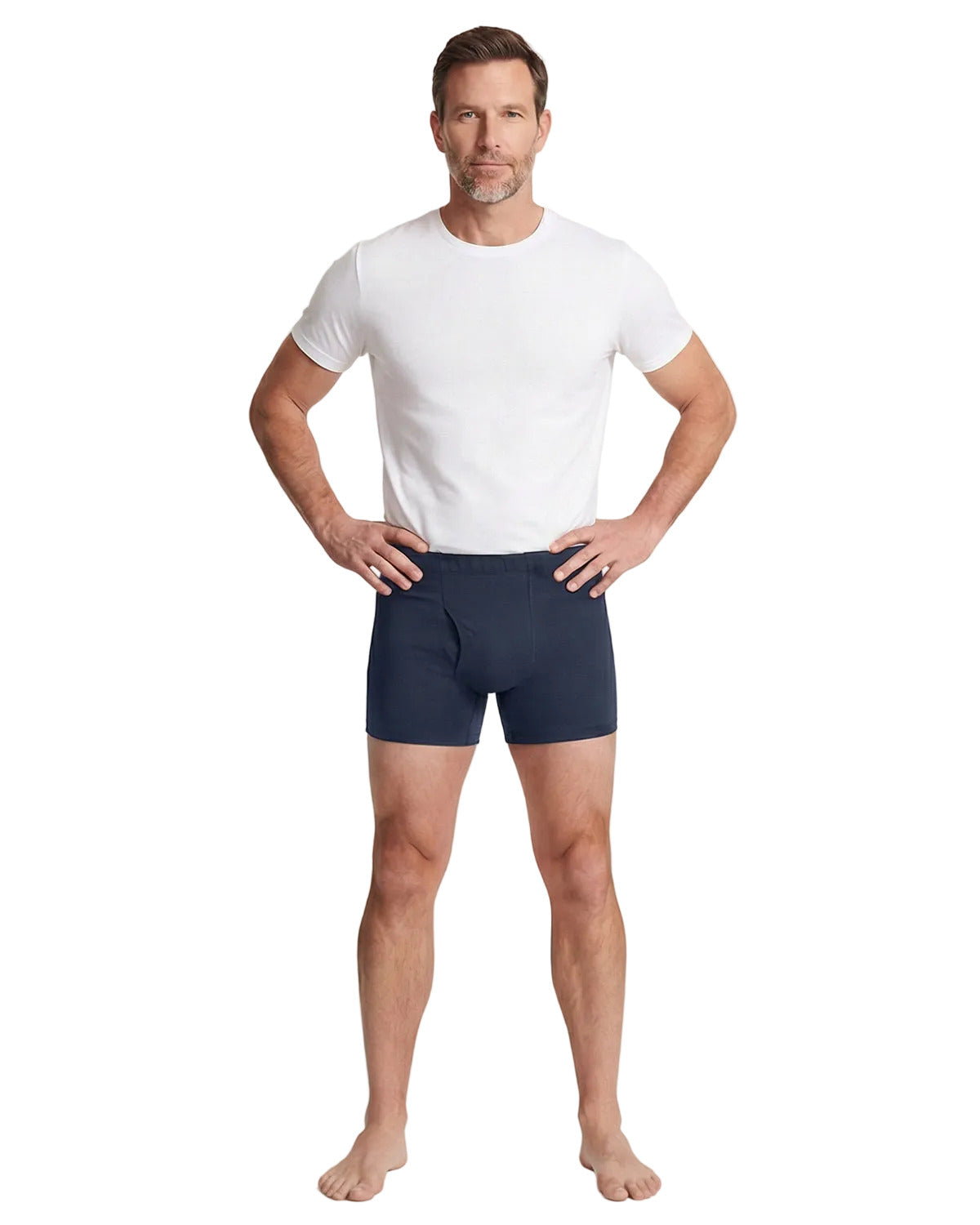 Man wearing navy boxer briefs and a white t-shirt on a white background