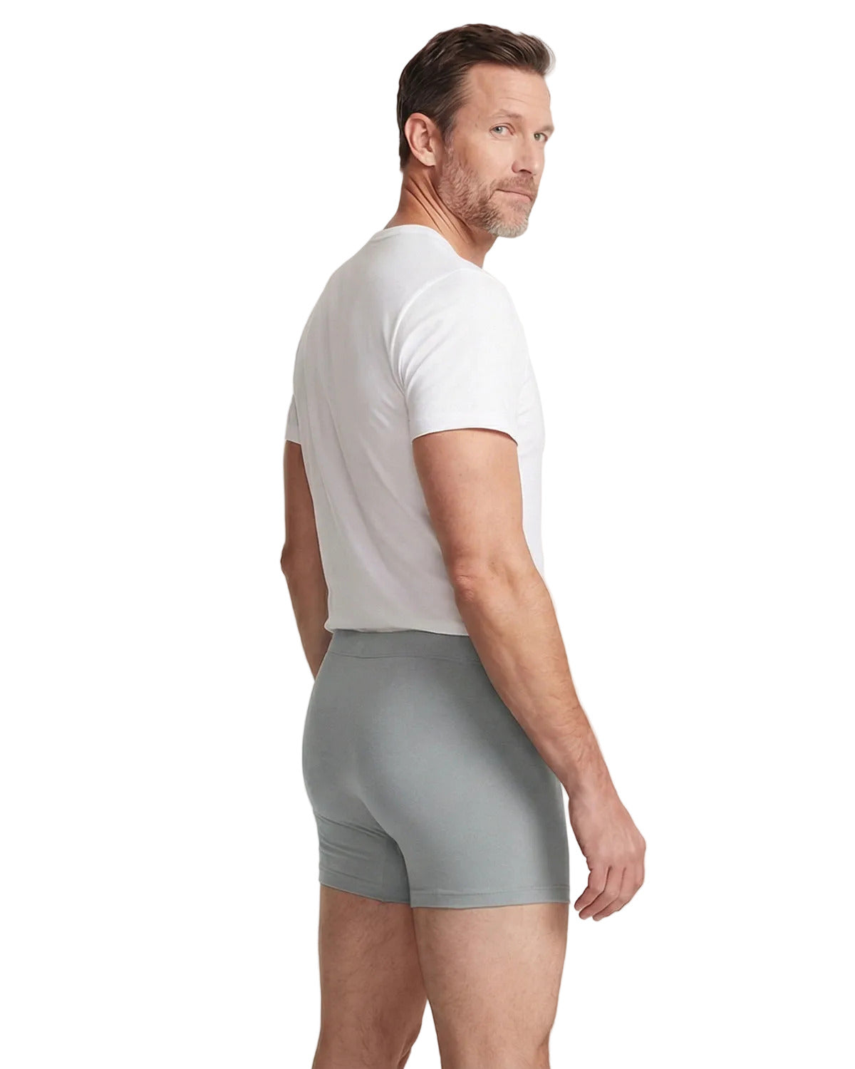 Man wearing gray boxer briefs and a white t-shirt on a light gray background
