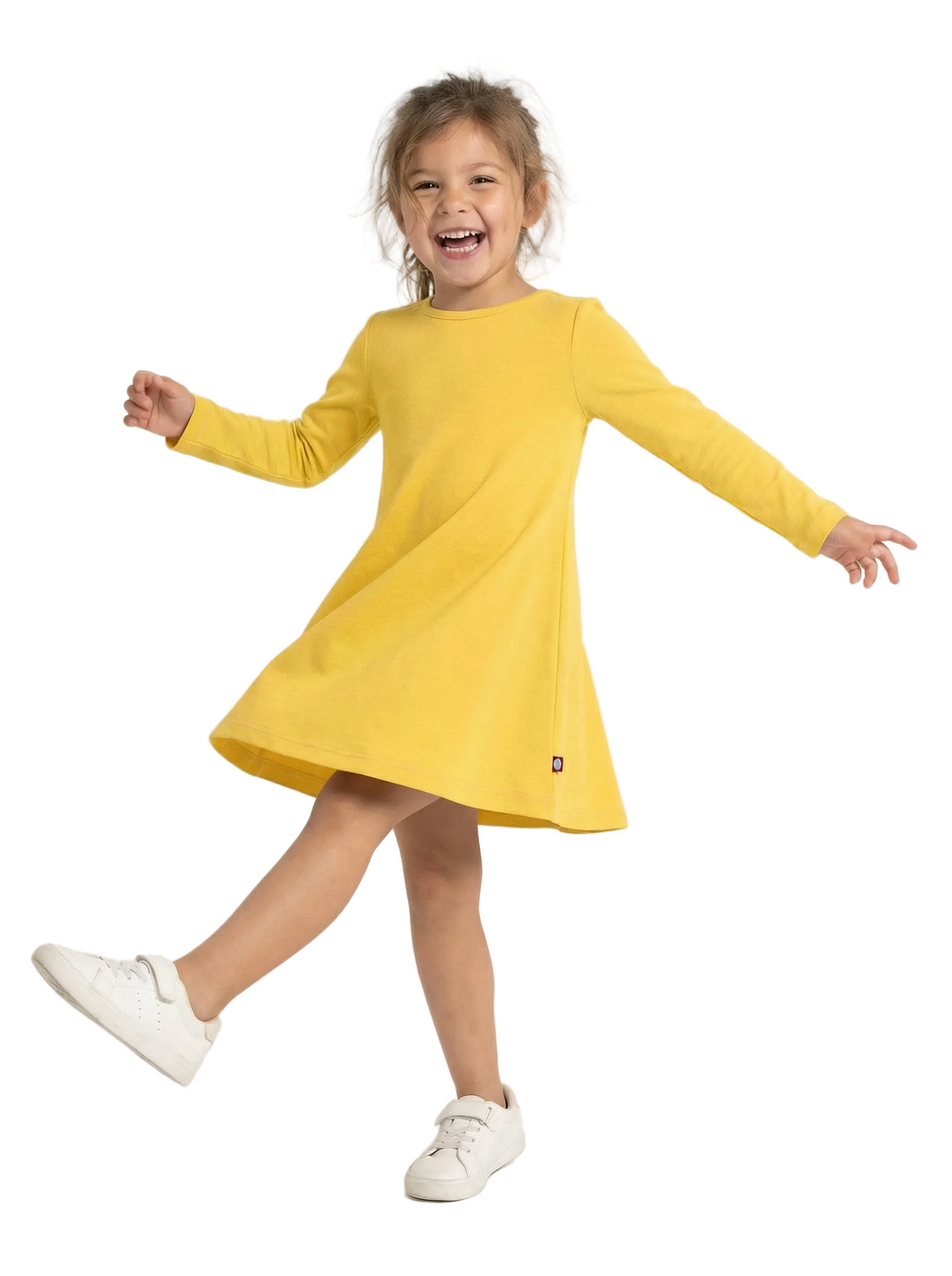 Child wearing a yellow dress on a white background